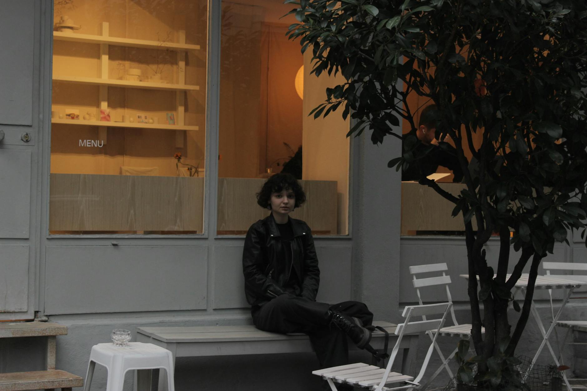 洗練された雰囲気のカフェの軒先でくつろぐジハンギルの女性。